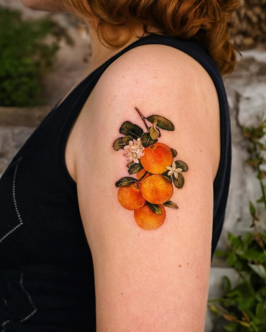 Stunning orange fruit tattoo on arm Tattoo on skin