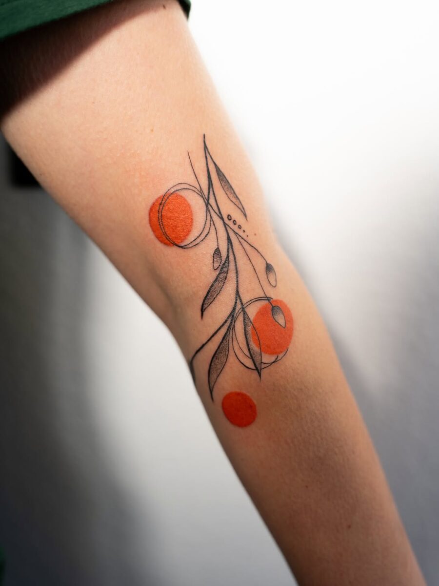 Stylish orange floral tattoo with abstract elements Tattoo on skin