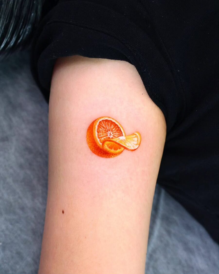 Vibrant orange tattoo with a realistic design Tattoo on skin