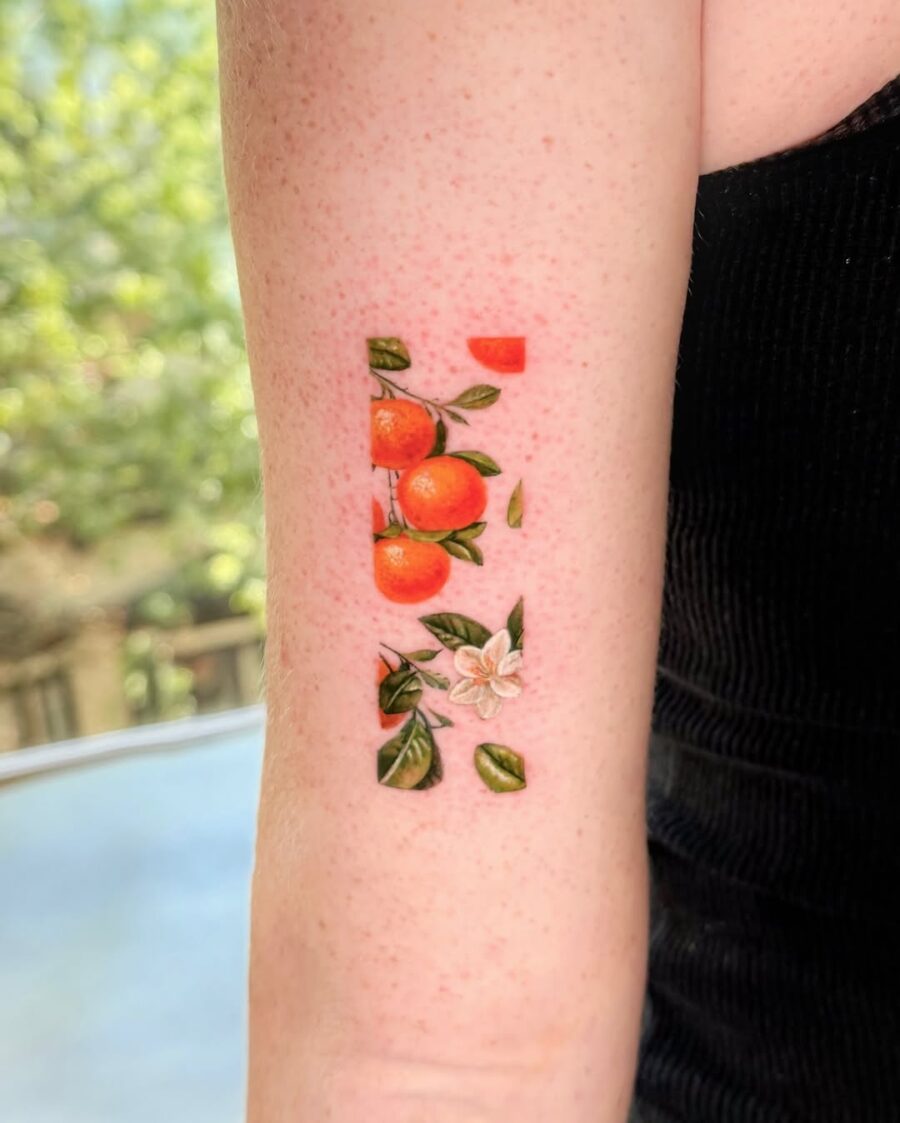 Vibrant orange tattoo with floral accents Tattoo on skin