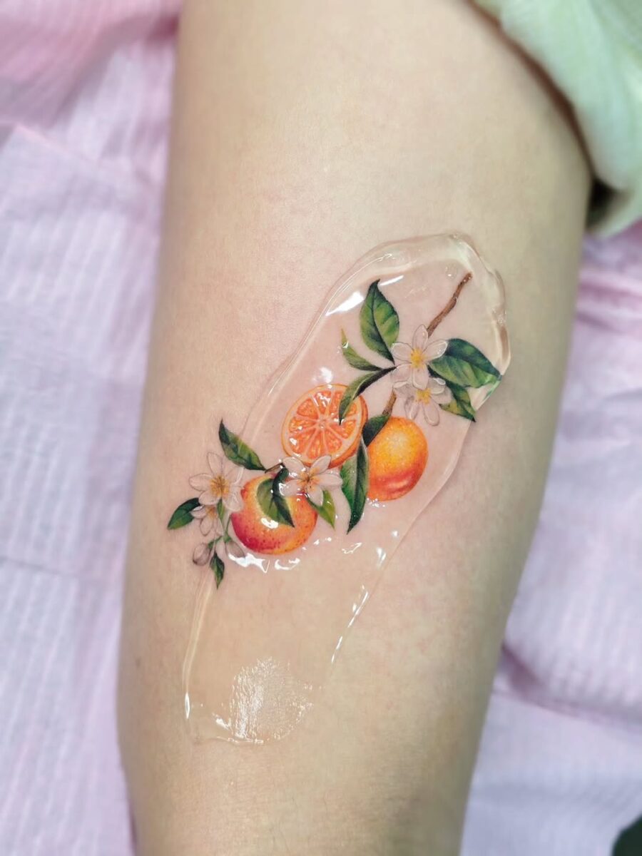 Vibrant Orange Tattoo with Floral Accents Tattoo on skin