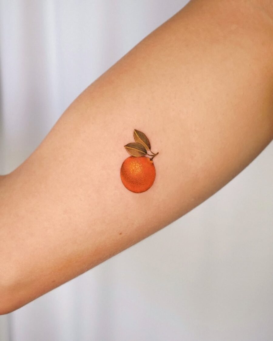 Vibrant orange tattoo with leafy detail Tattoo on skin