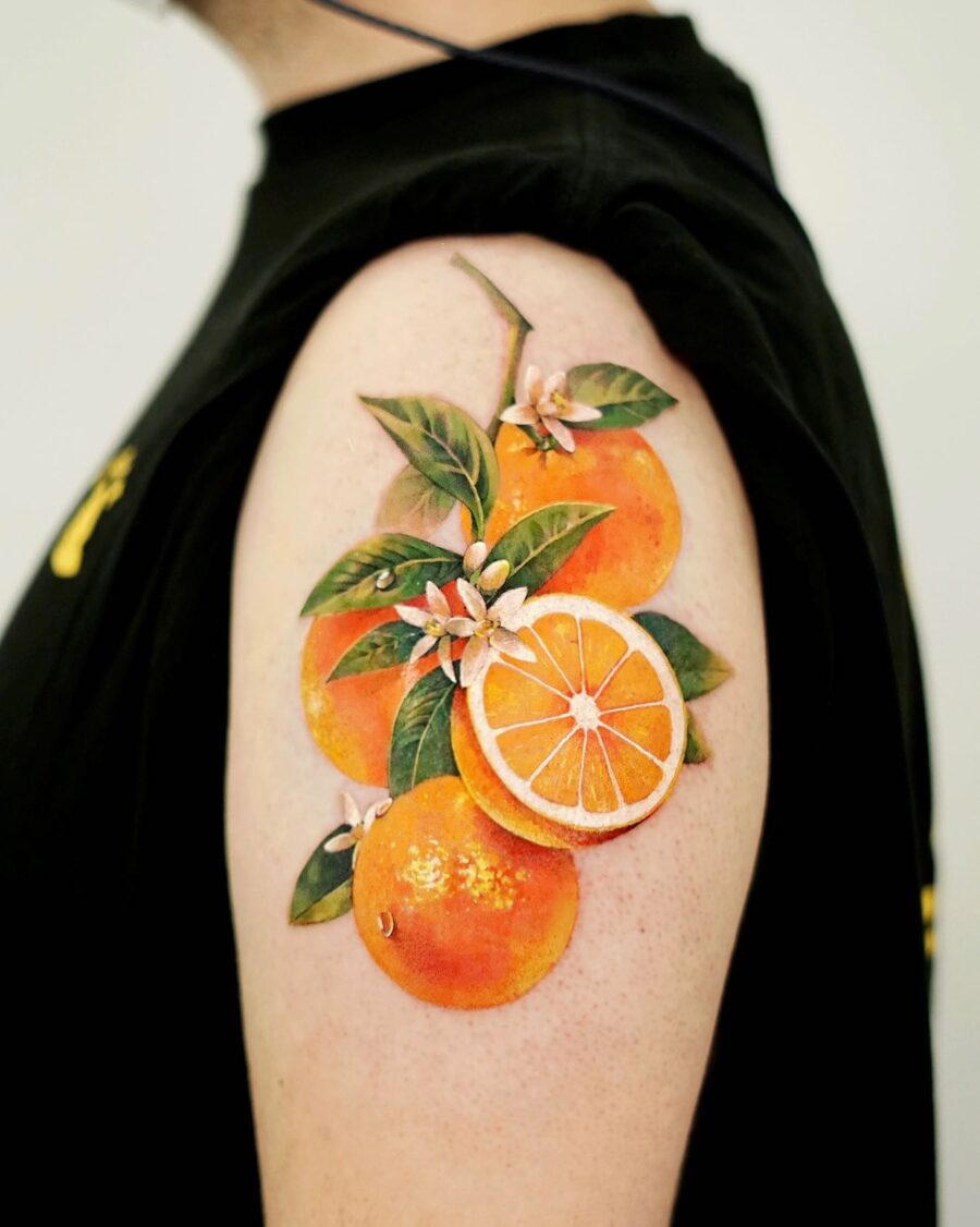 Vibrant orange tattoo with lush foliage Tattoo on skin
