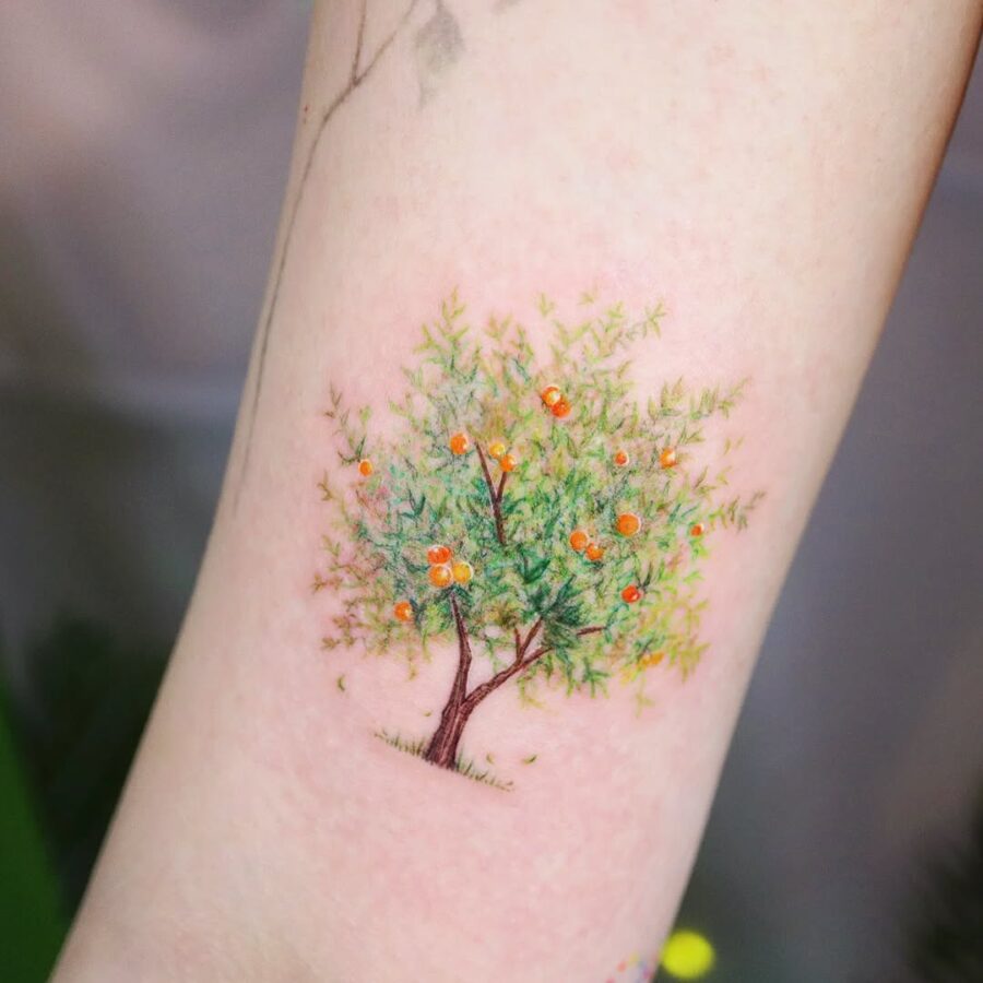 Vibrant orange tree tattoo symbolizing growth Tattoo on skin