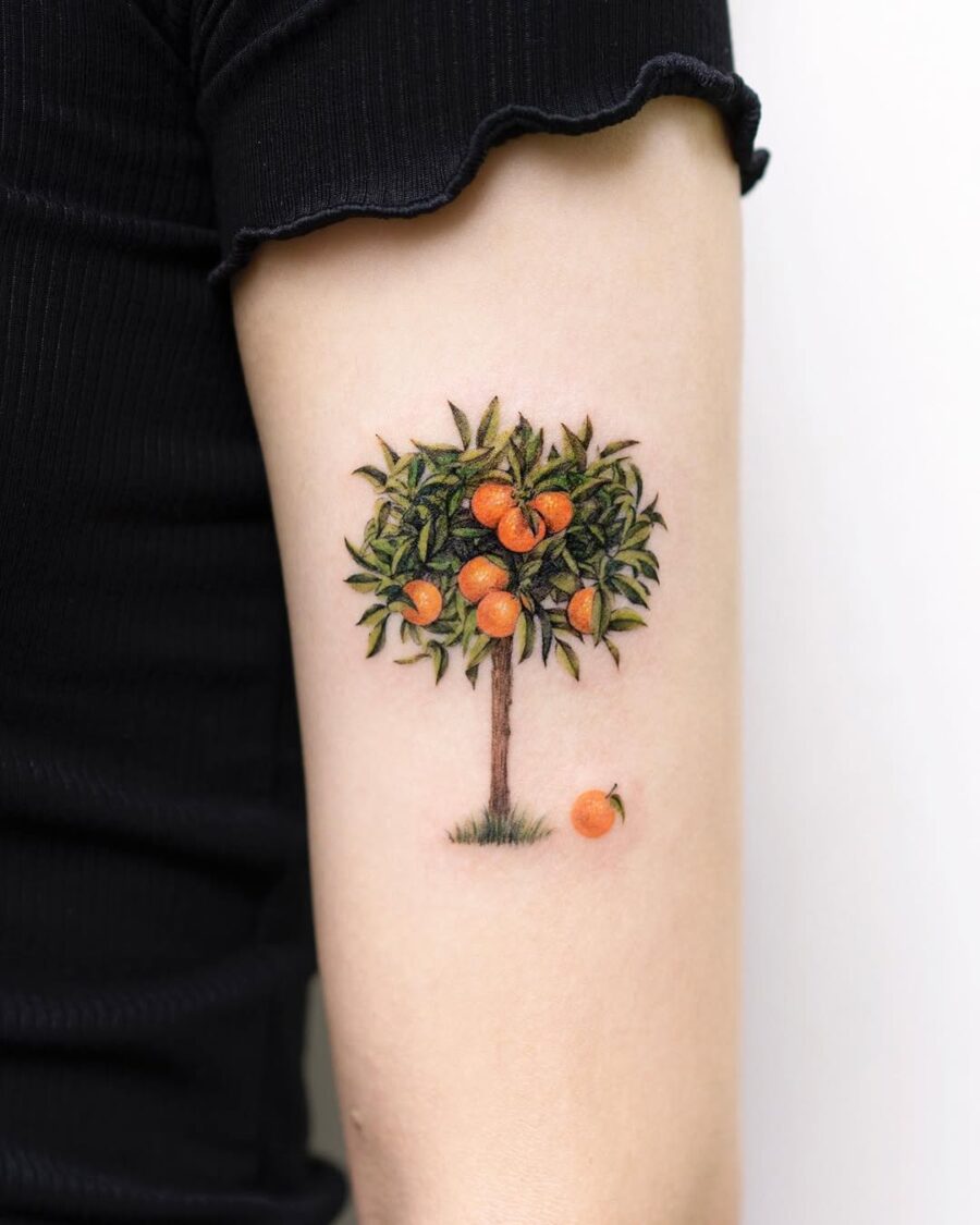 Vibrant Orange Tree Tattoo with Lush Foliage Tattoo on skin