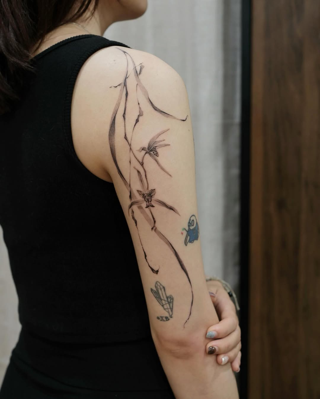 Artistic orchid tattoo on a woman's arm Tattoo on skin
