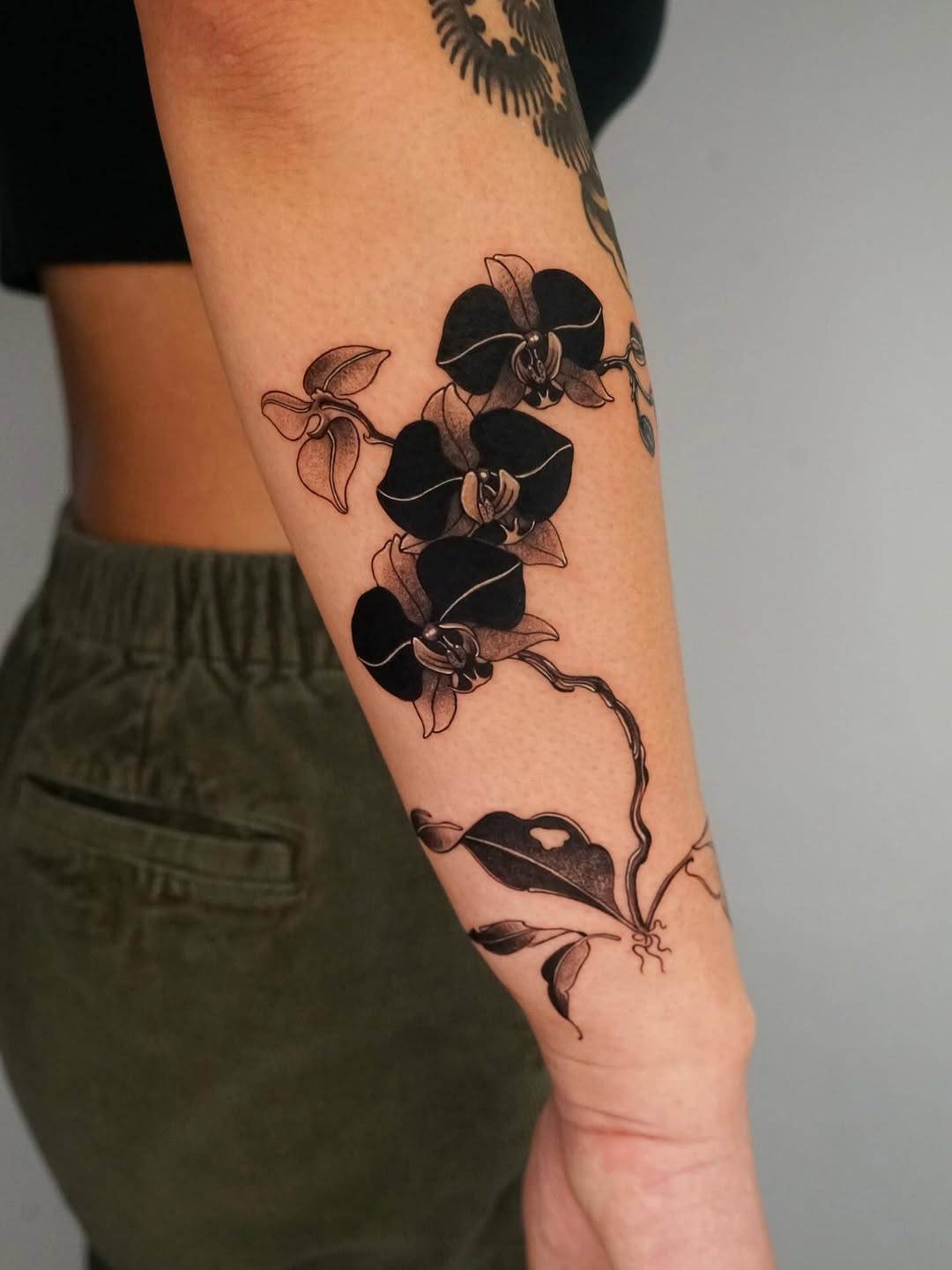 Elegant black orchid tattoo on forearm orchid tattoos