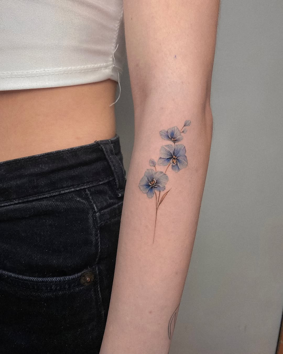 Elegant orchid tattoo design on the arm Tattoo on skin