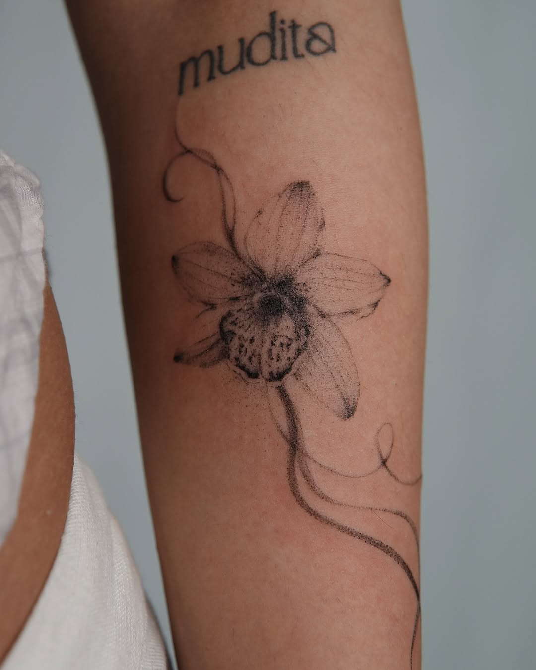 Elegant orchid tattoo with intricate details Tattoo on skin