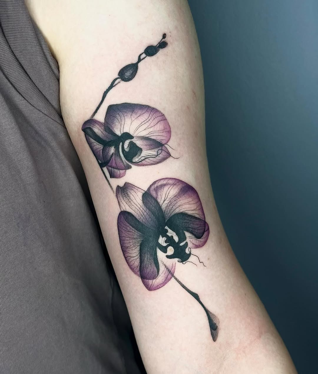 Elegant orchid tattoo with intricate details Tattoo on skin