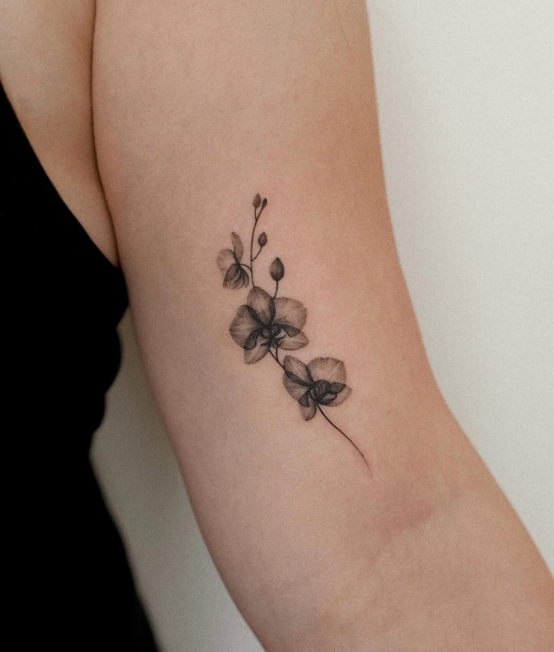 Elegantly unique black and white orchid tattoo Tattoo on skin