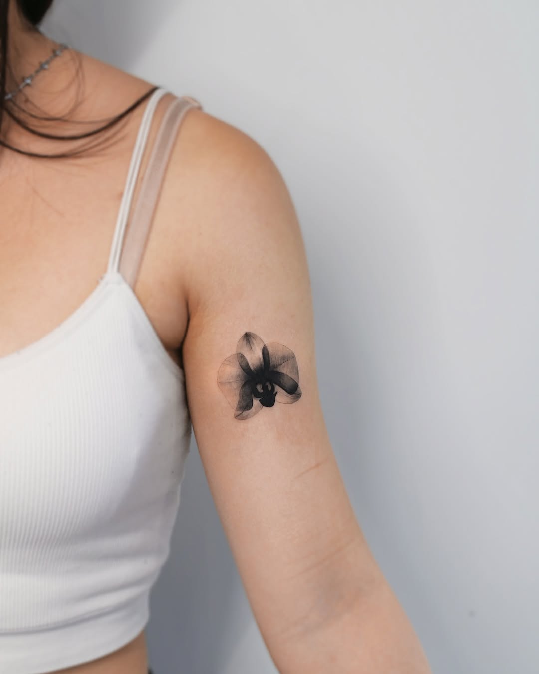 Stunning black orchid tattoo on the arm Tattoo on skin