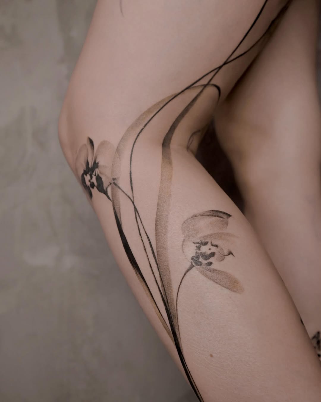 Stunning orchid tattoo with fluid lines Tattoo on skin