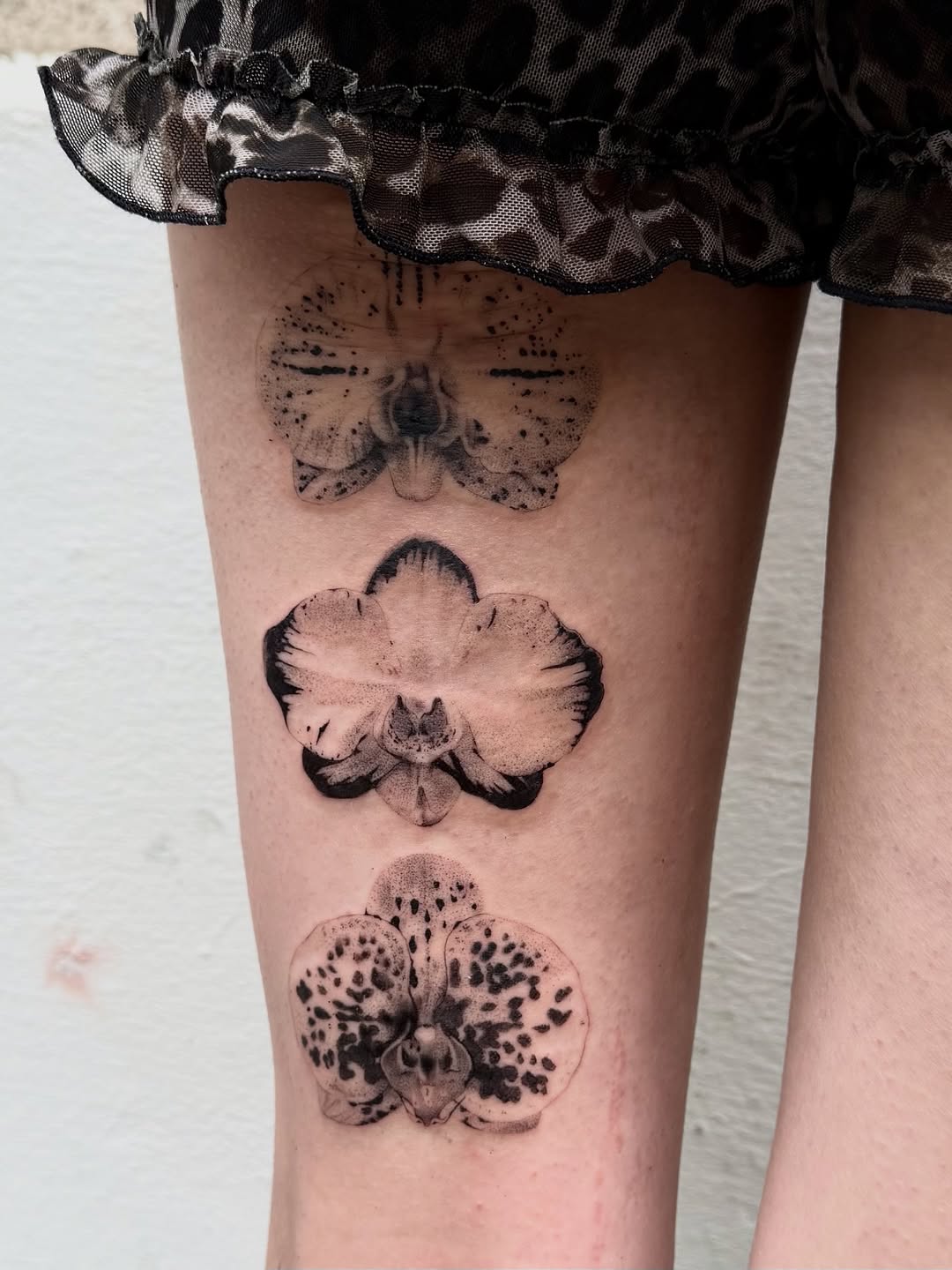 Stunning Orchid Tattoos on Thigh for Nature Lovers Tattoo on skin