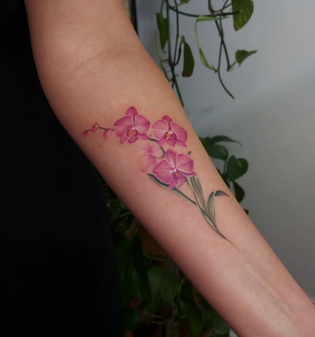 Stunning pink orchid tattoo on forearm Tattoo on skin
