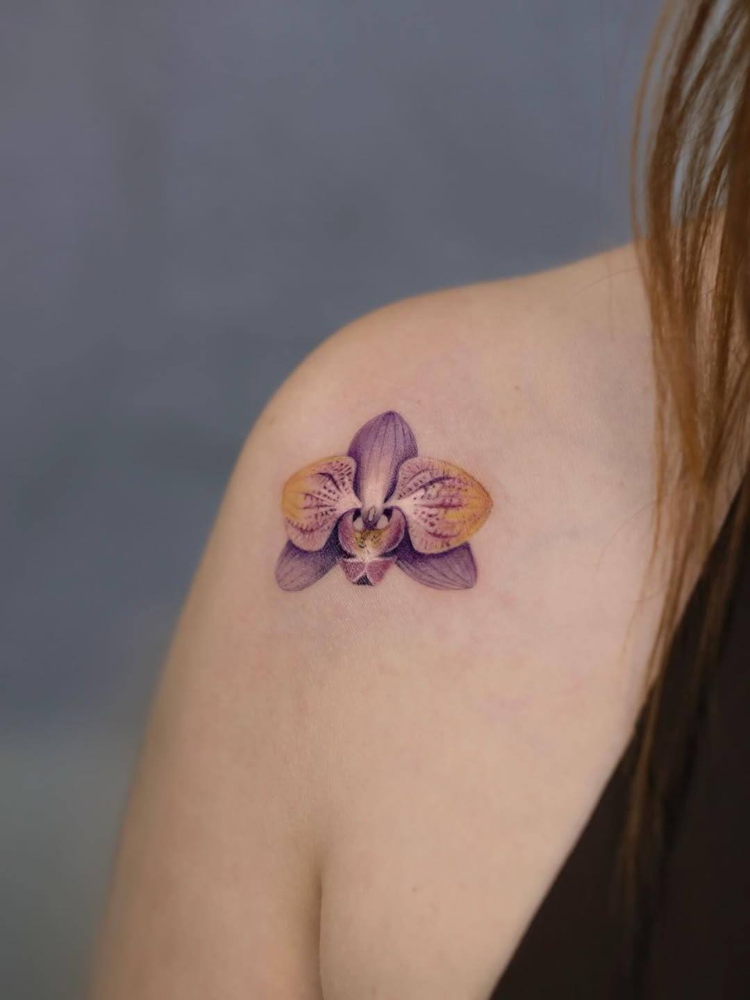 Stunning purple orchid tattoo on shoulder Tattoo on skin