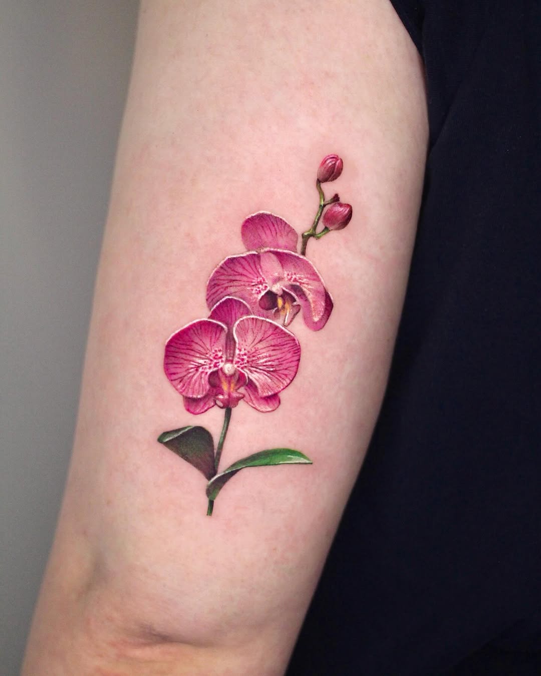 Stunning vibrant orchid tattoo in bloom Tattoo on skin