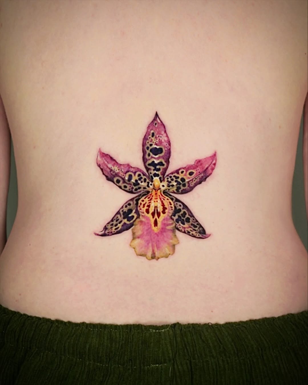 Stunning watercolor orchid tattoo design on back Tattoo on skin