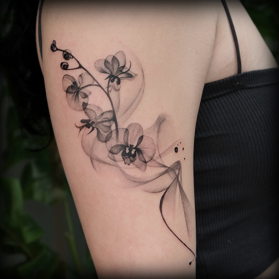 Stylish black orchid tattoo on arm Tattoo on skin