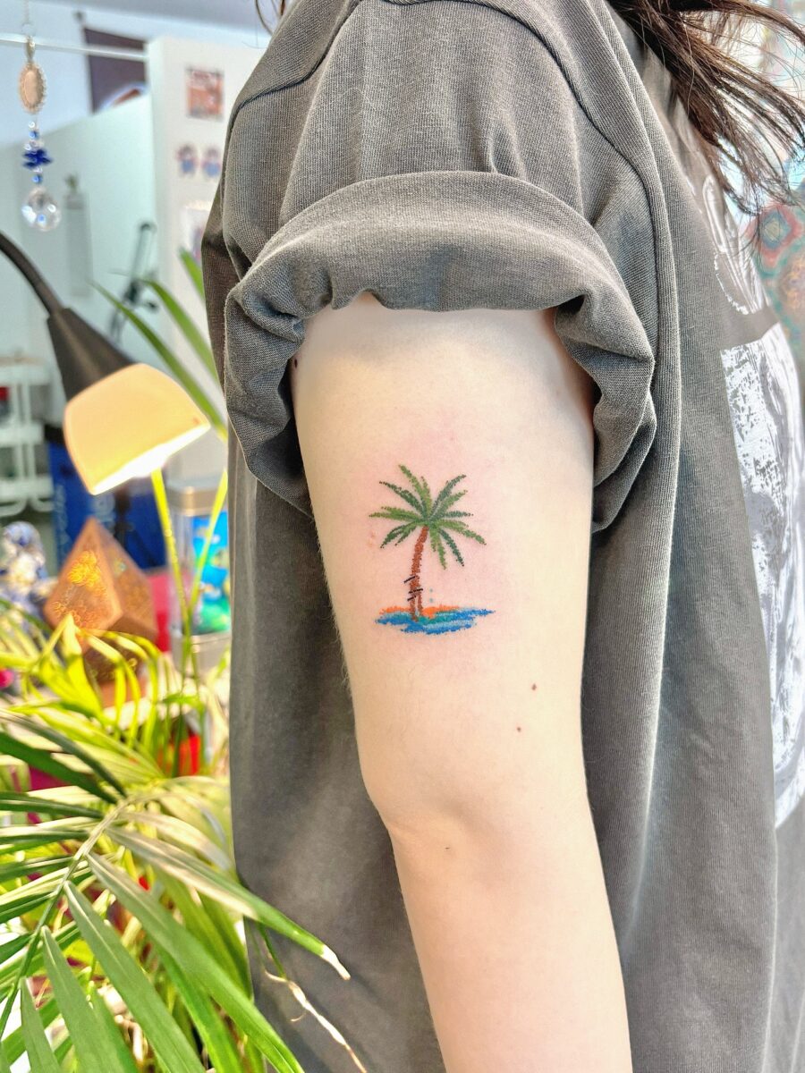 Charming palm tree tattoo on upper arm Tattoo on skin