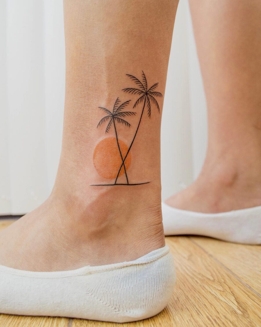 Charming palm tree tattoo with sunset vibe Tattoo on skin