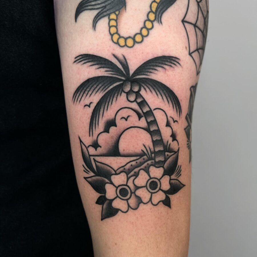 Delightful palm tree tattoo with sunset elements Tattoo on skin