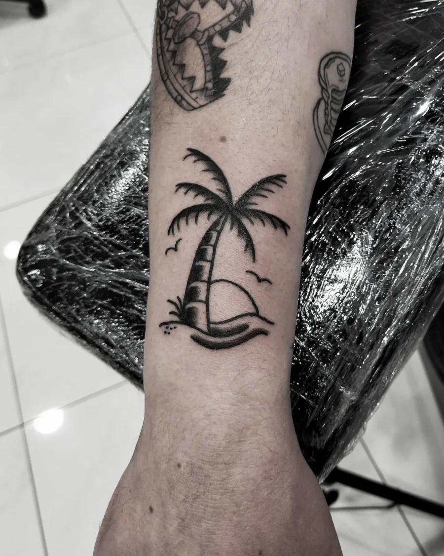 Elegant minimalist palm tree tattoo design Tattoo on skin