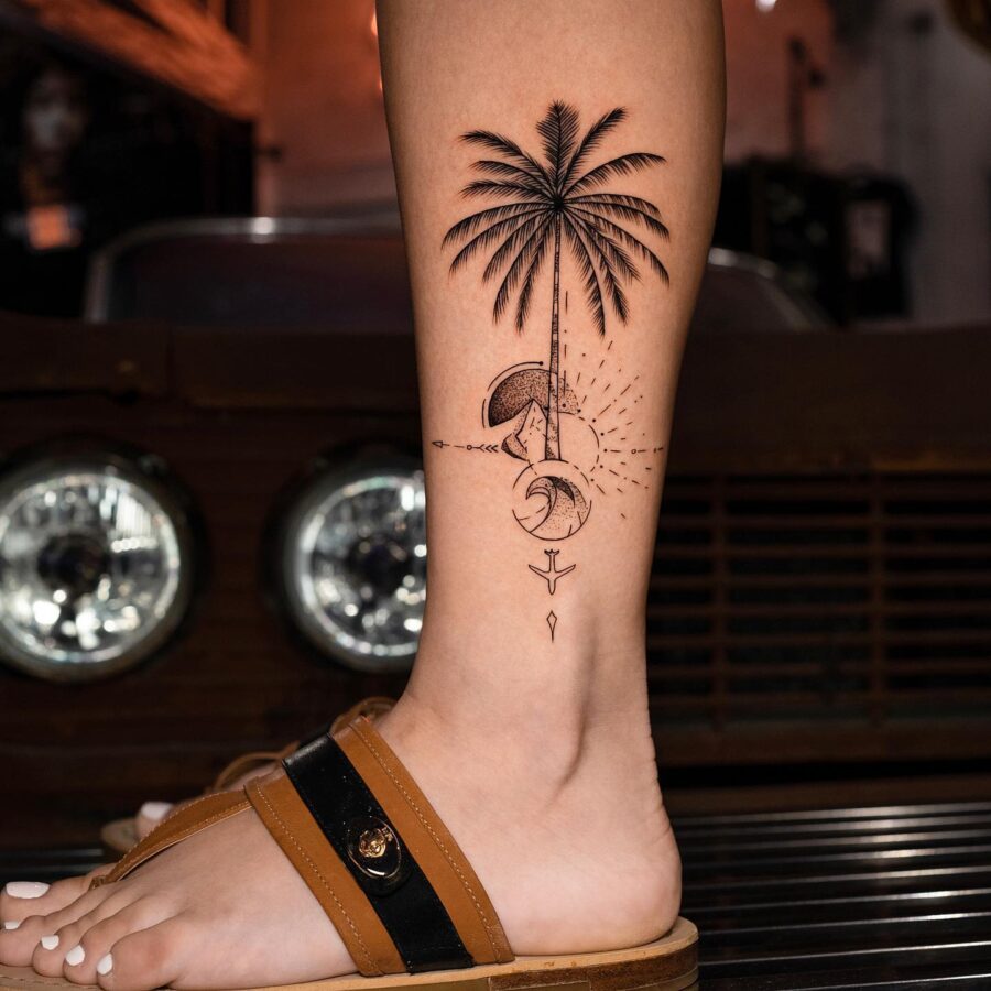 Elegant Palm Tree Tattoo with Celestial Elements Tattoo on skin