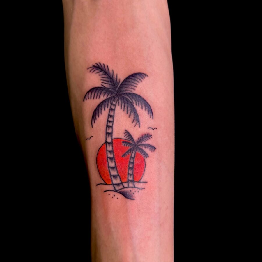 Elegant palm tree tattoo with sunset backdrop Tattoo on skin