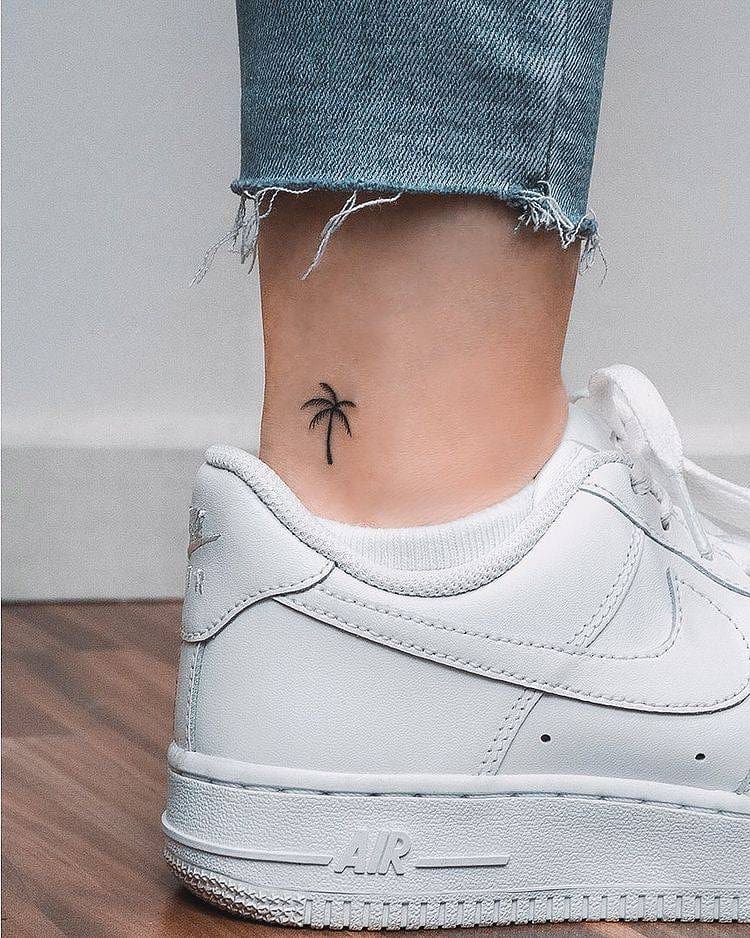 Minimalist palm tree tattoo on the ankle Tattoo on skin