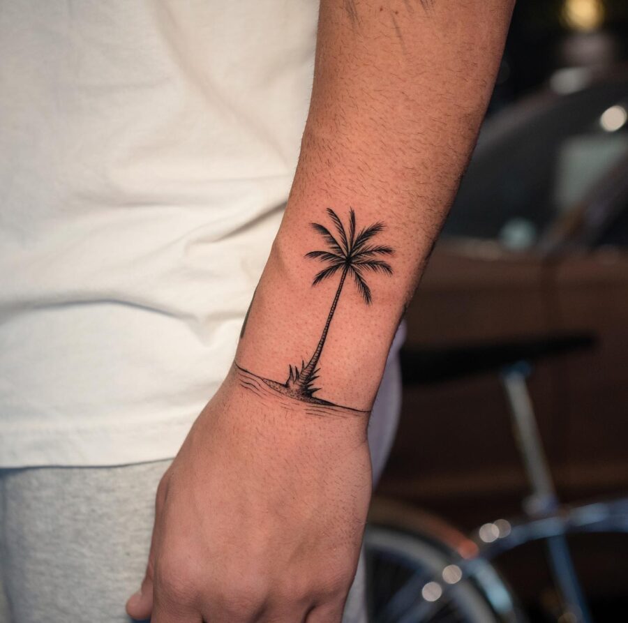 Minimalistic palm tree tattoo on forearm Tattoo on skin