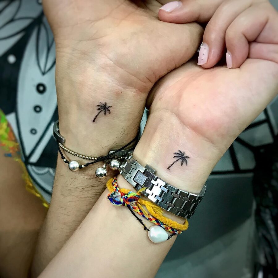 Minimalistic palm tree tattoos on wrists Tattoo on skin