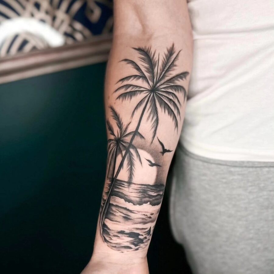 Stunning palm tree tattoo with ocean backdrop Tattoo on skin