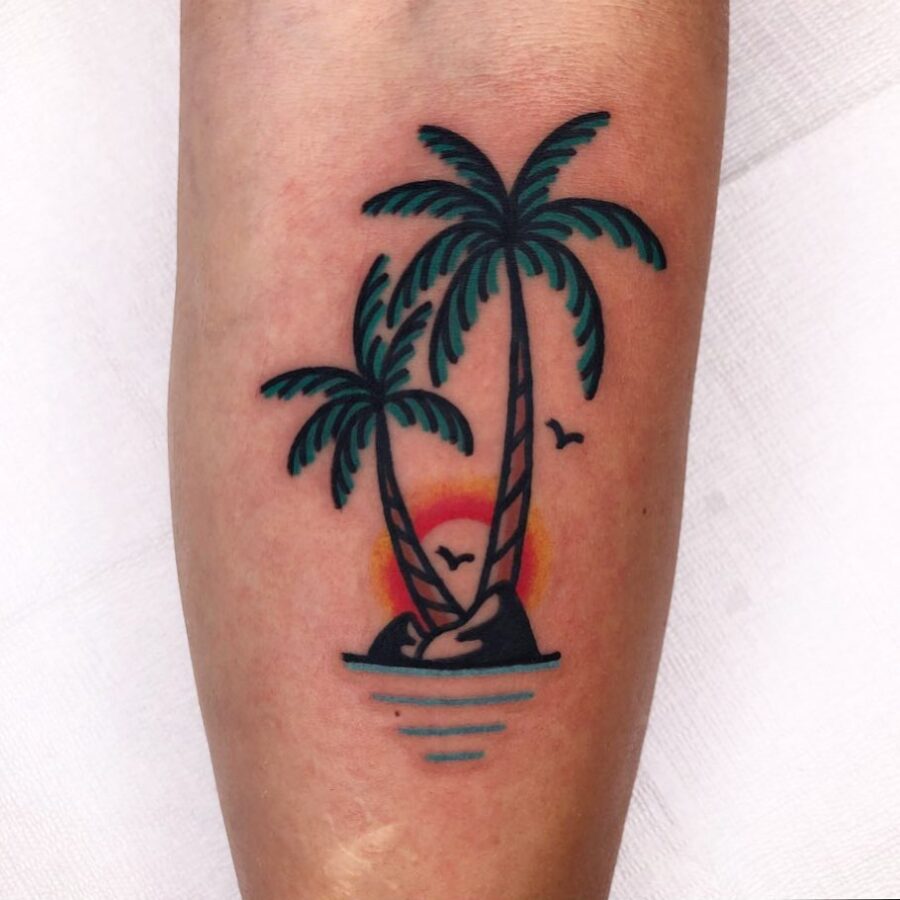 Vibrant palm tree tattoo with island backdrop Tattoo on skin