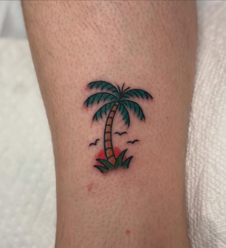 Vibrant Palm Tree Tattoo with Nature Elements Tattoo on skin