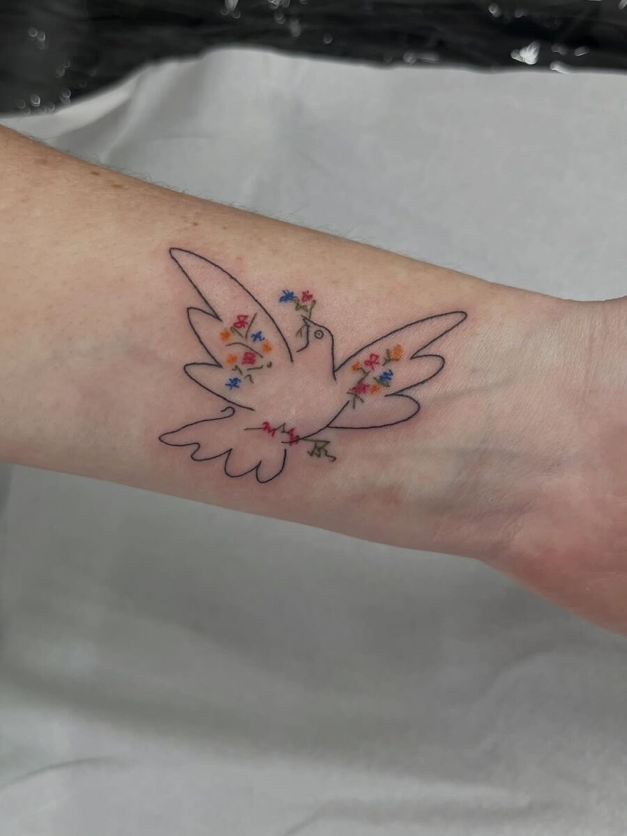 Colorful dove tattoo symbolizing peace and harmony Tattoo on skin