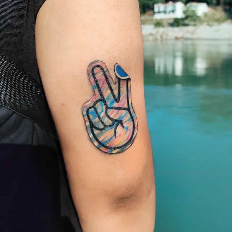 Colorful peace sign tattoo on arm close-up Tattoo on skin
