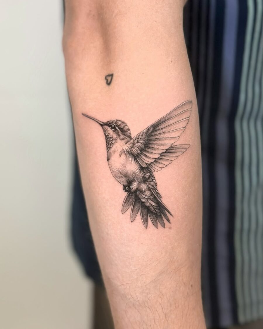 Elegant hummingbird tattoo symbolizing peace and freedom Tattoo on skin