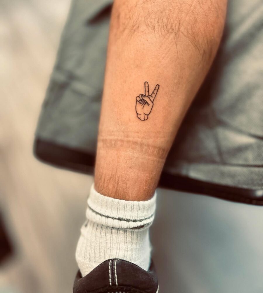 Minimalist peace sign tattoo on inner leg Tattoo on skin
