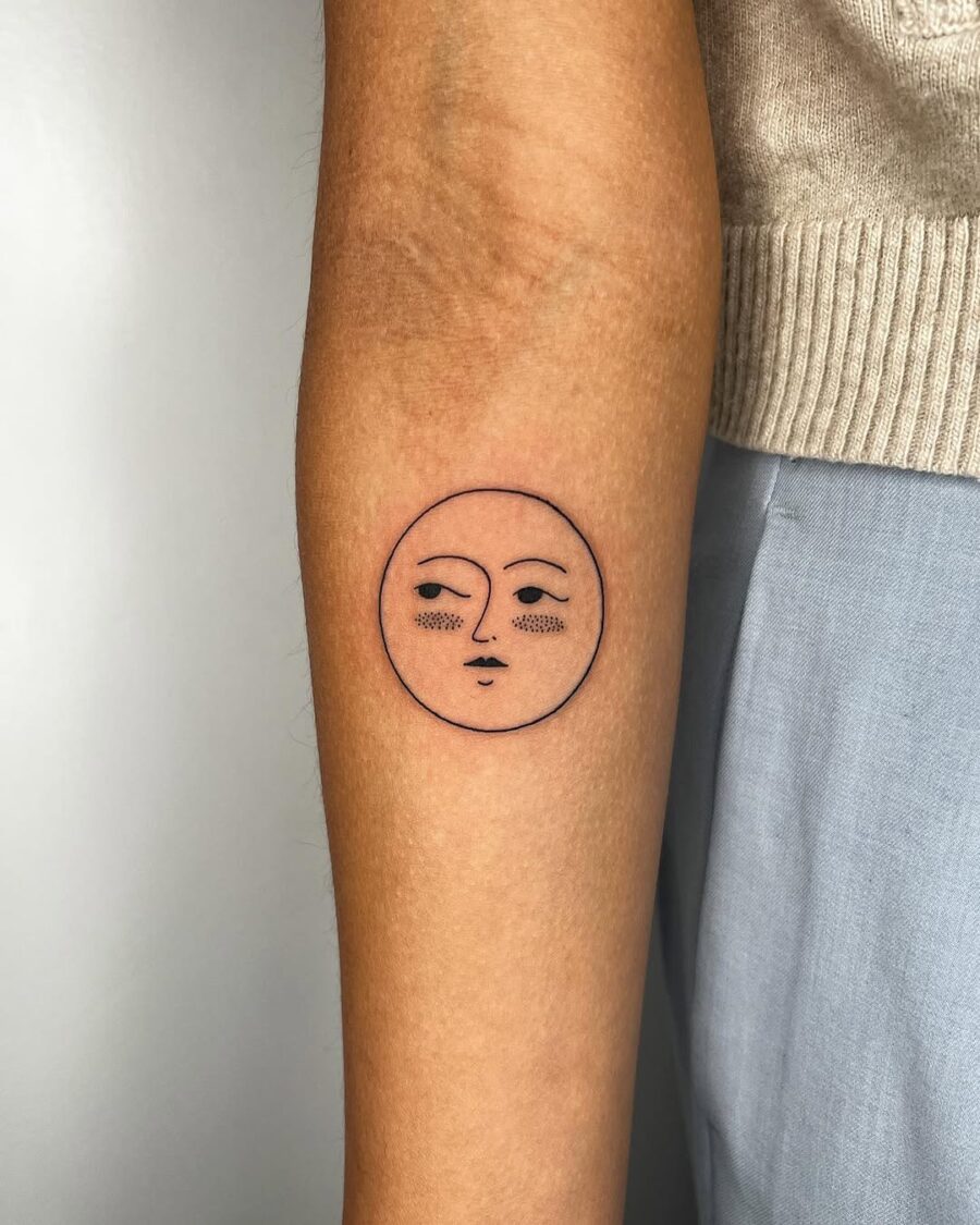 Minimalist sun face tattoo radiating calm vibes Tattoo on skin