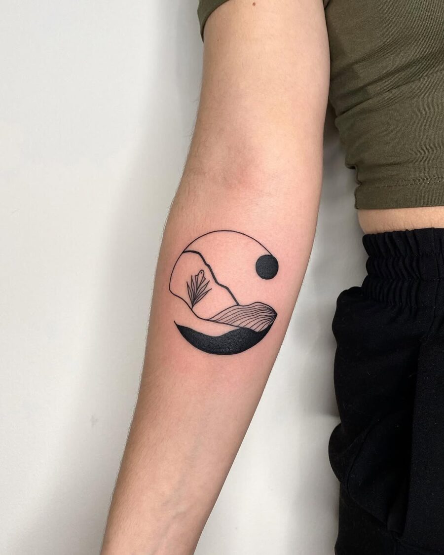 Serene mountain landscape with minimalist sun design Tattoo on skin