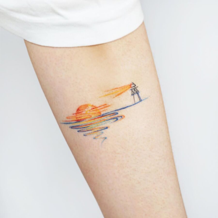 Serene sunset with lighthouse tattoo inspiration Tattoo on skin