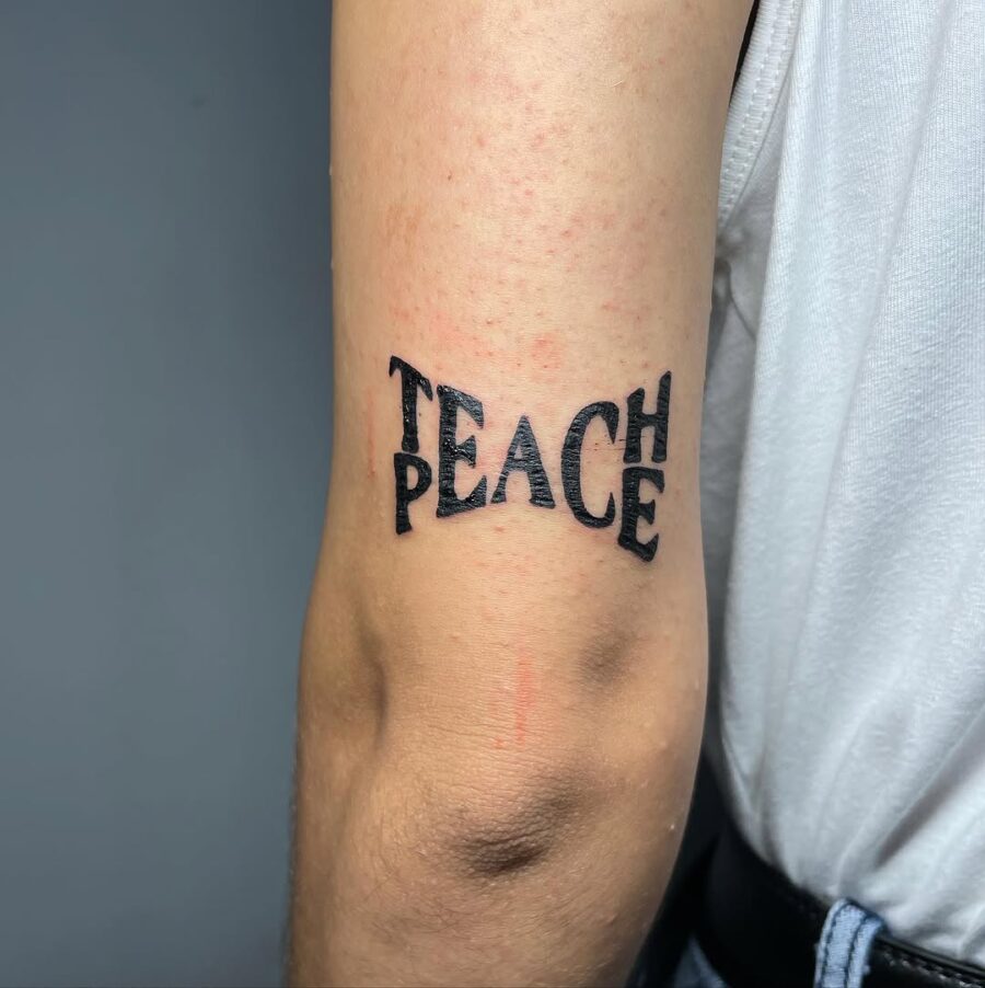 Unique Peace Tattoo with a Teaching Twist Tattoo on skin