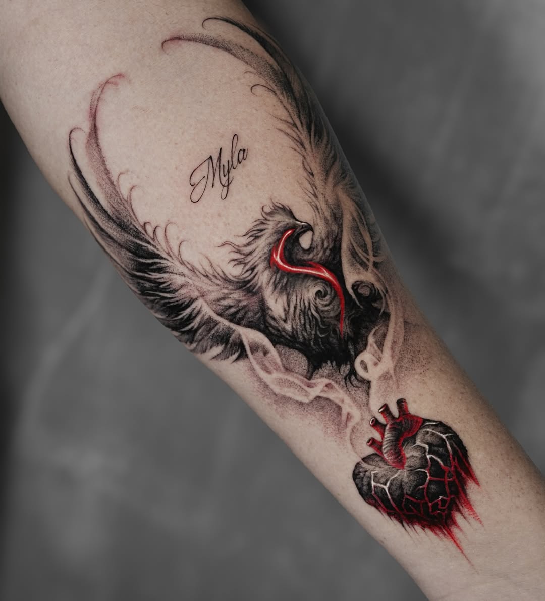 Artistic phoenix tattoo with a heart motif Tattoo on skin