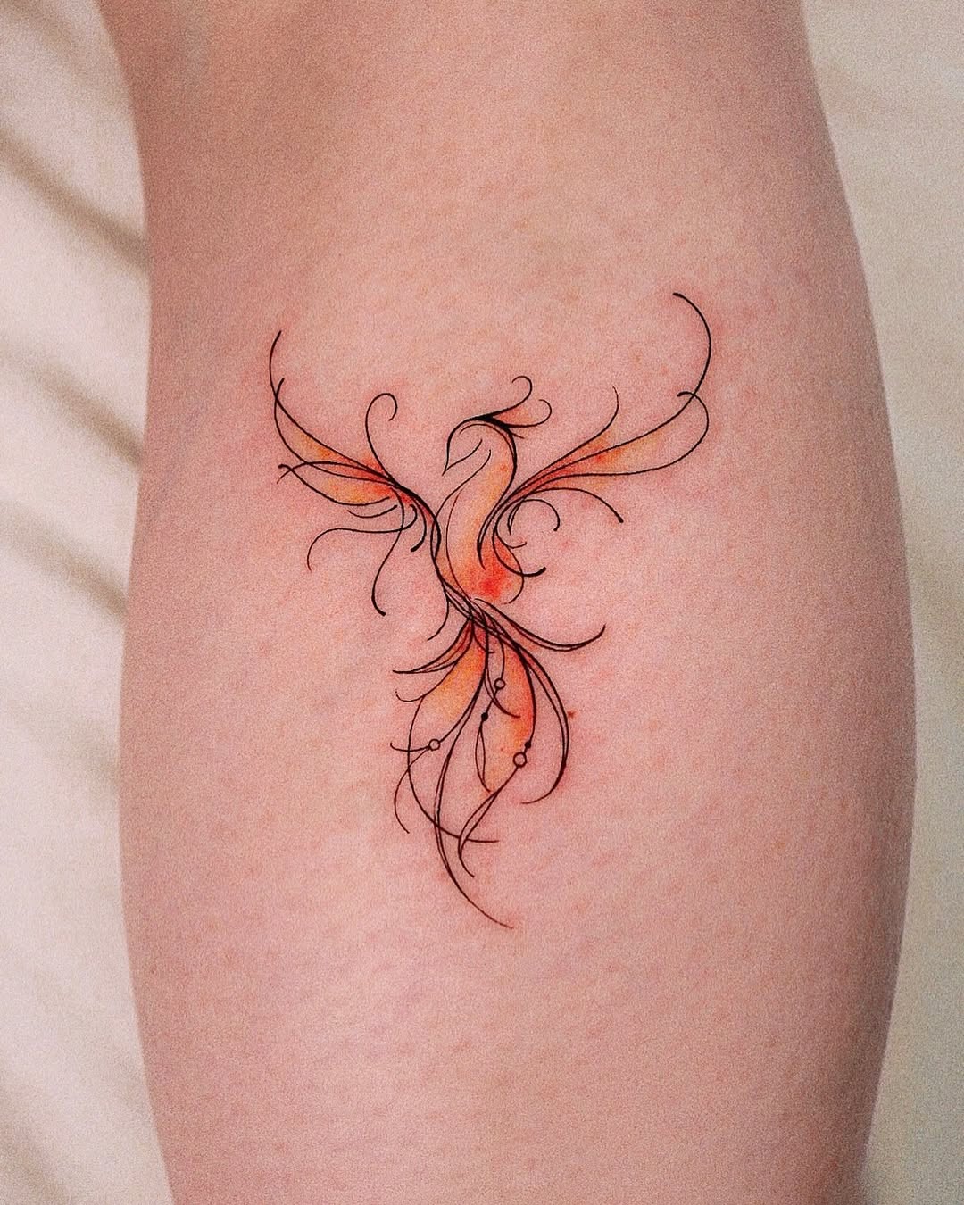 Artistic Phoenix Tattoo with Flowing Lines Tattoo on skin