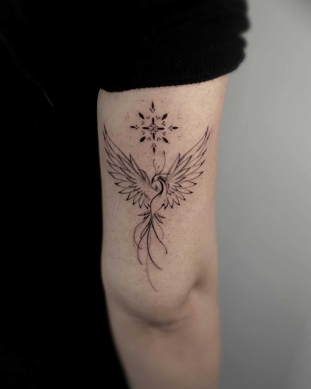 Elegant phoenix tattoo with graceful wings Tattoo on skin