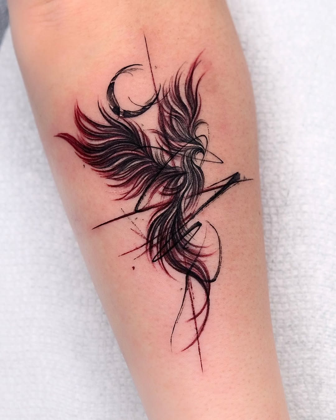 Elegant phoenix tattoo with striking red accents Tattoo on skin