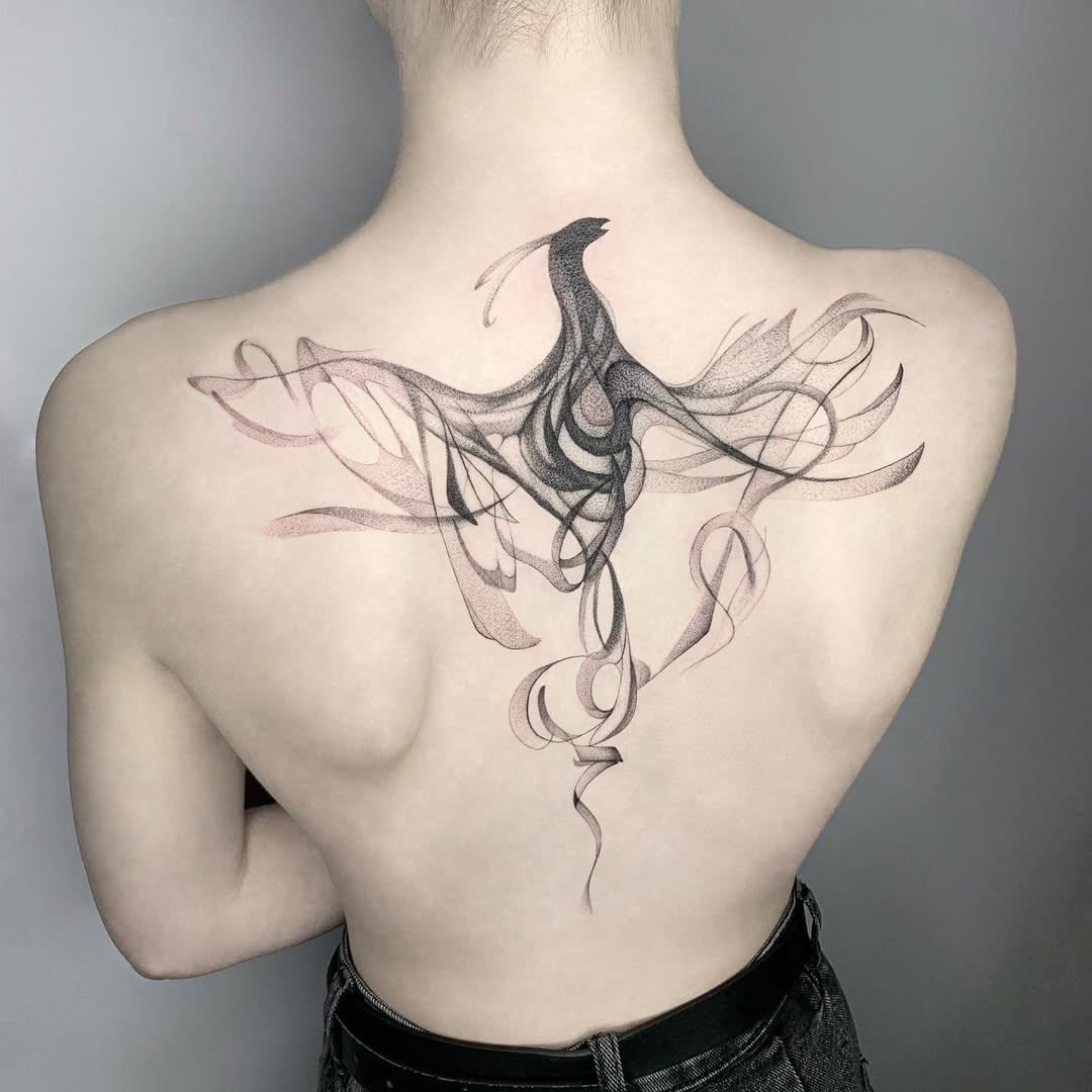 Elegant swirling phoenix tattoo on the back Tattoo on skin