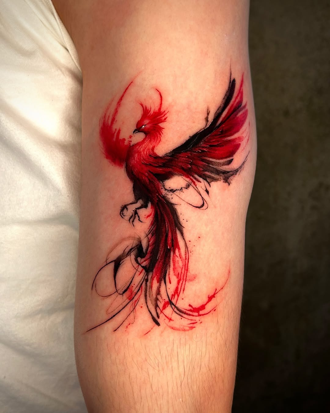 Striking phoenix tattoo in fiery hues Tattoo on skin