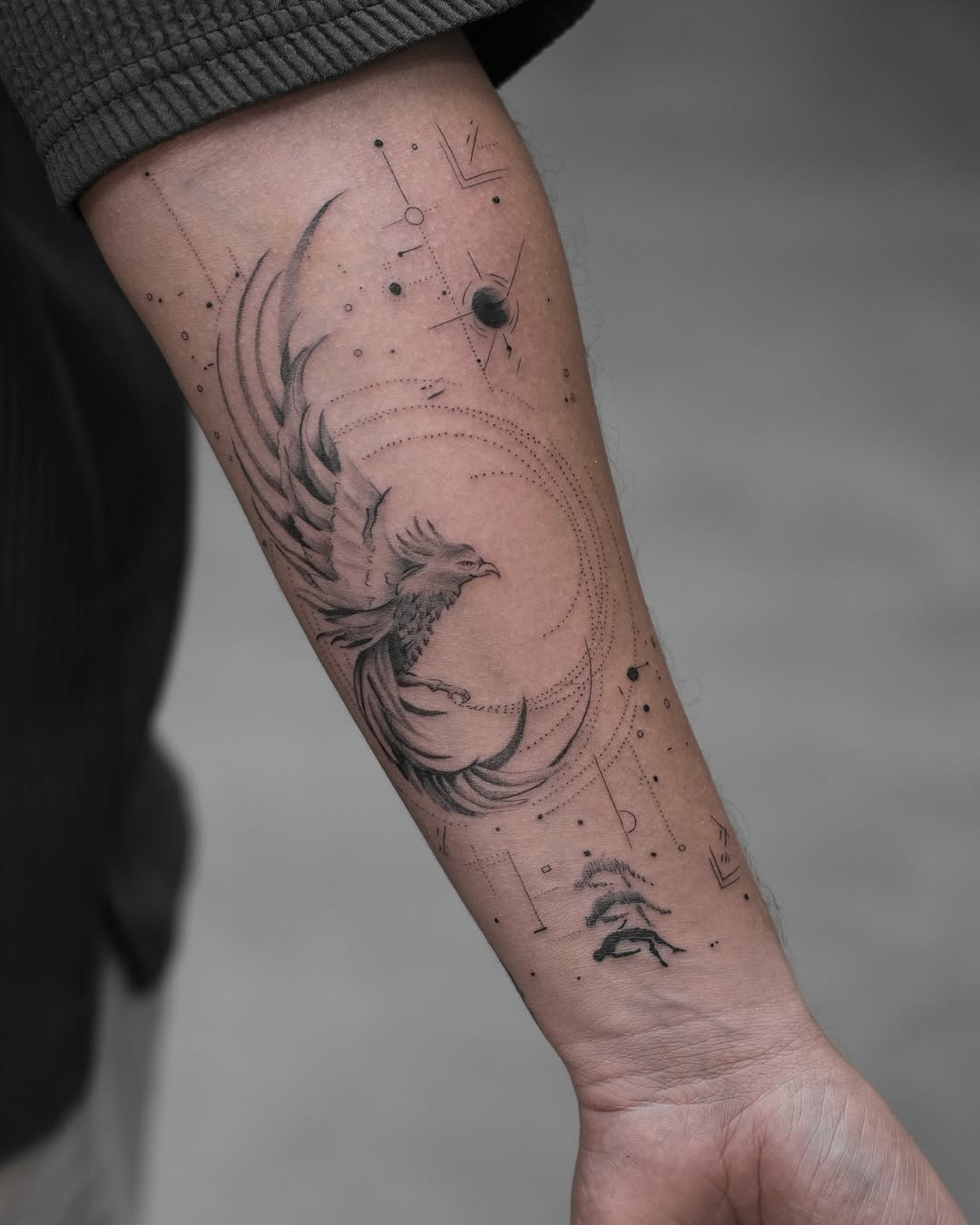 Stunning phoenix tattoo with cosmic elements Tattoo on skin